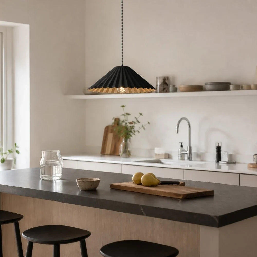 Black metal dome pendant lamp above a kitchen island