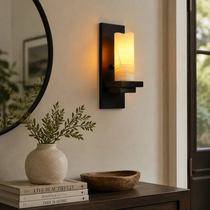 Compact wall sconce near a mirror and console