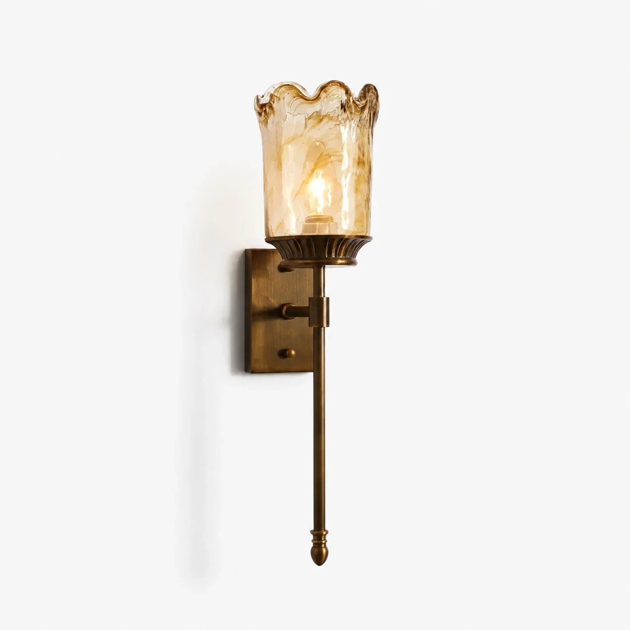 Brass amber glass wall sconce on clean background