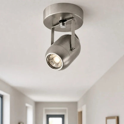 Adjustable wall lamp adding warm accent light near an entryway