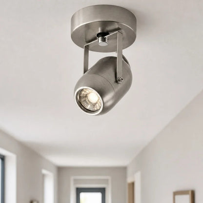 Adjustable wall lamp adding warm accent light near an entryway