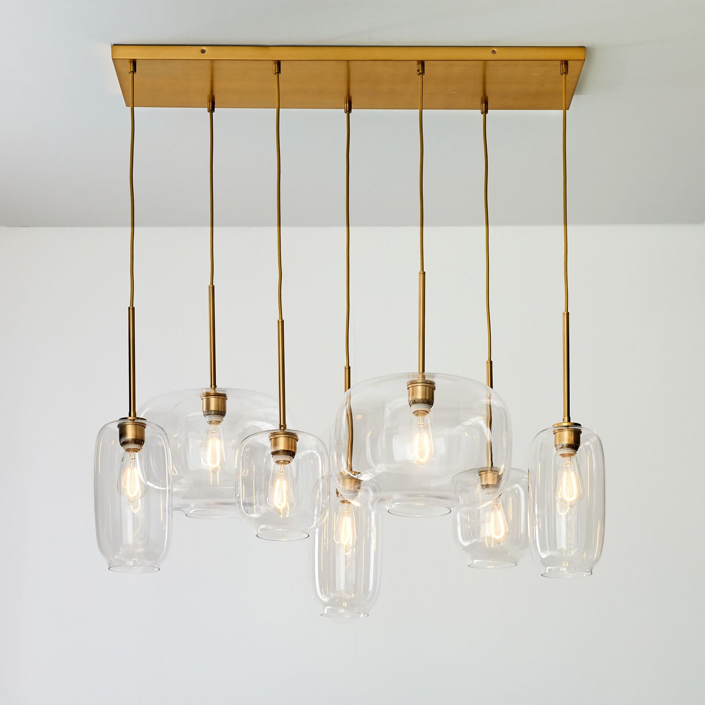 Lumivelle Sculptural 7-Light Chandelier – Adjustable Height Modern Glass Pendant