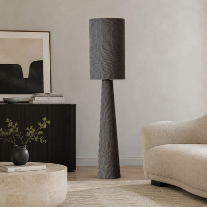 Gray striped floor lamp near a console and lounge chair